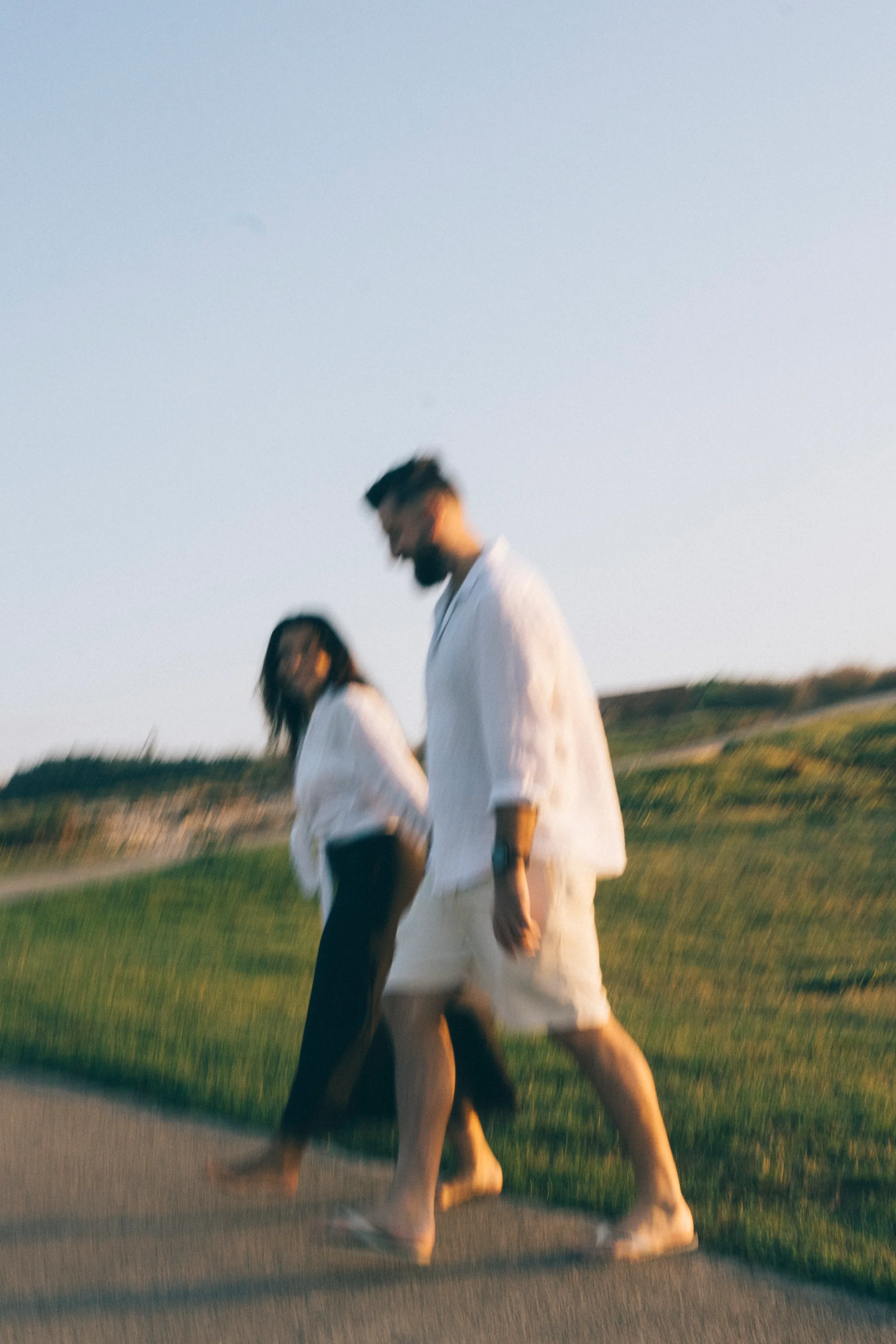 A couple holding hands in a blurry sunrise, Sydney