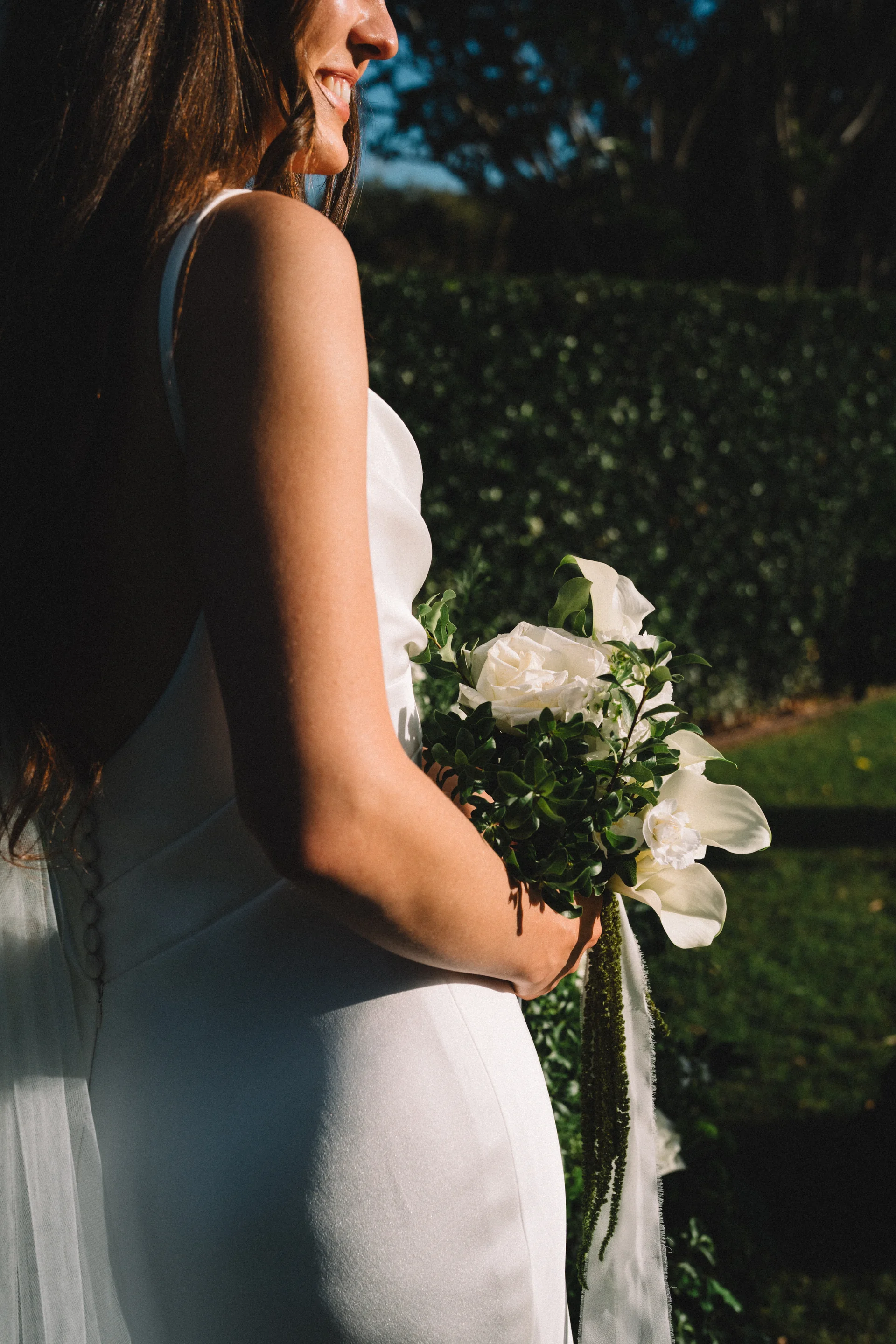A bride holding a white bouquet in a garden, Sydney