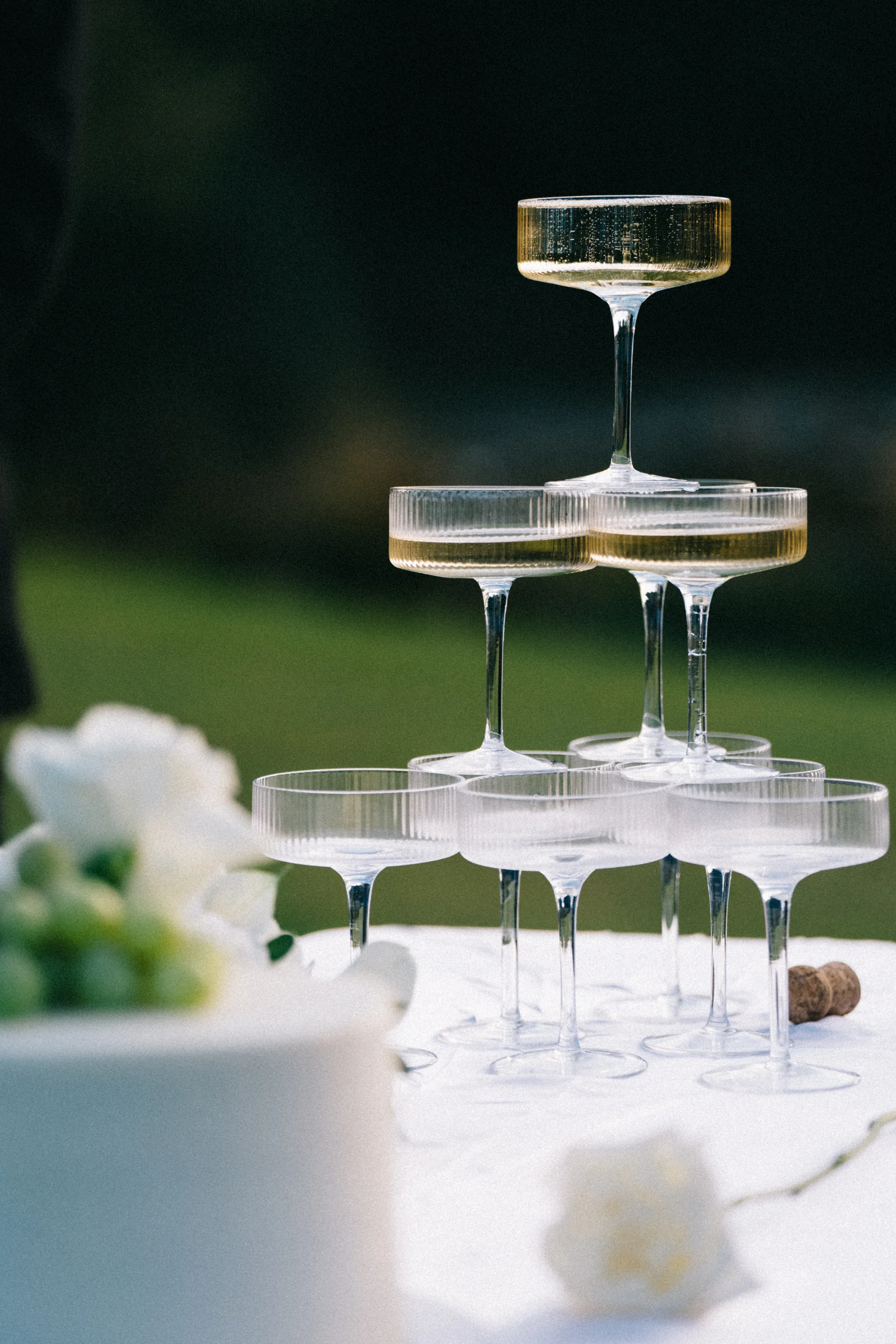 A tower of champagne coupes on an outdoor table, Sydney