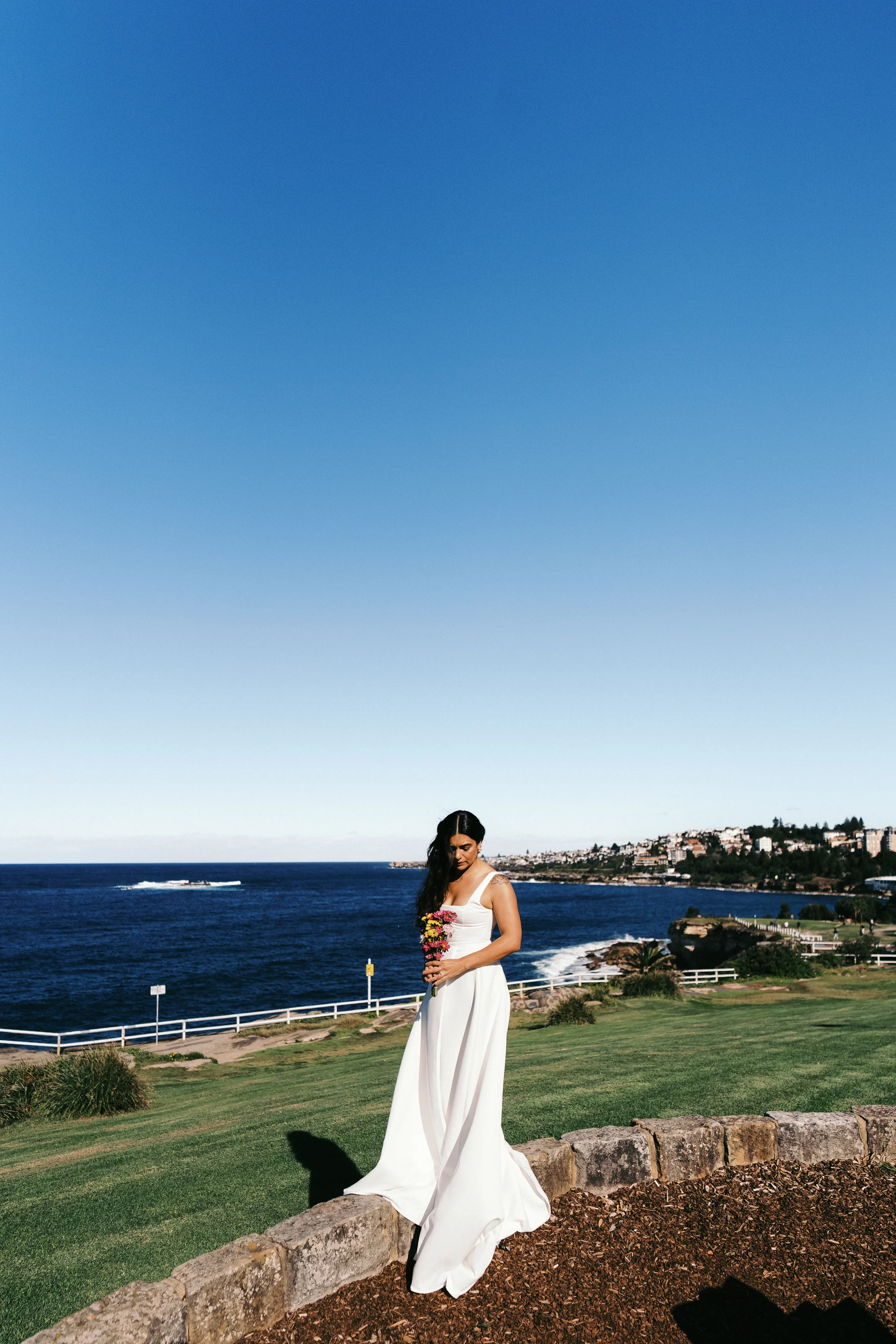 Above the coast, Bouquet in hand, blue sky