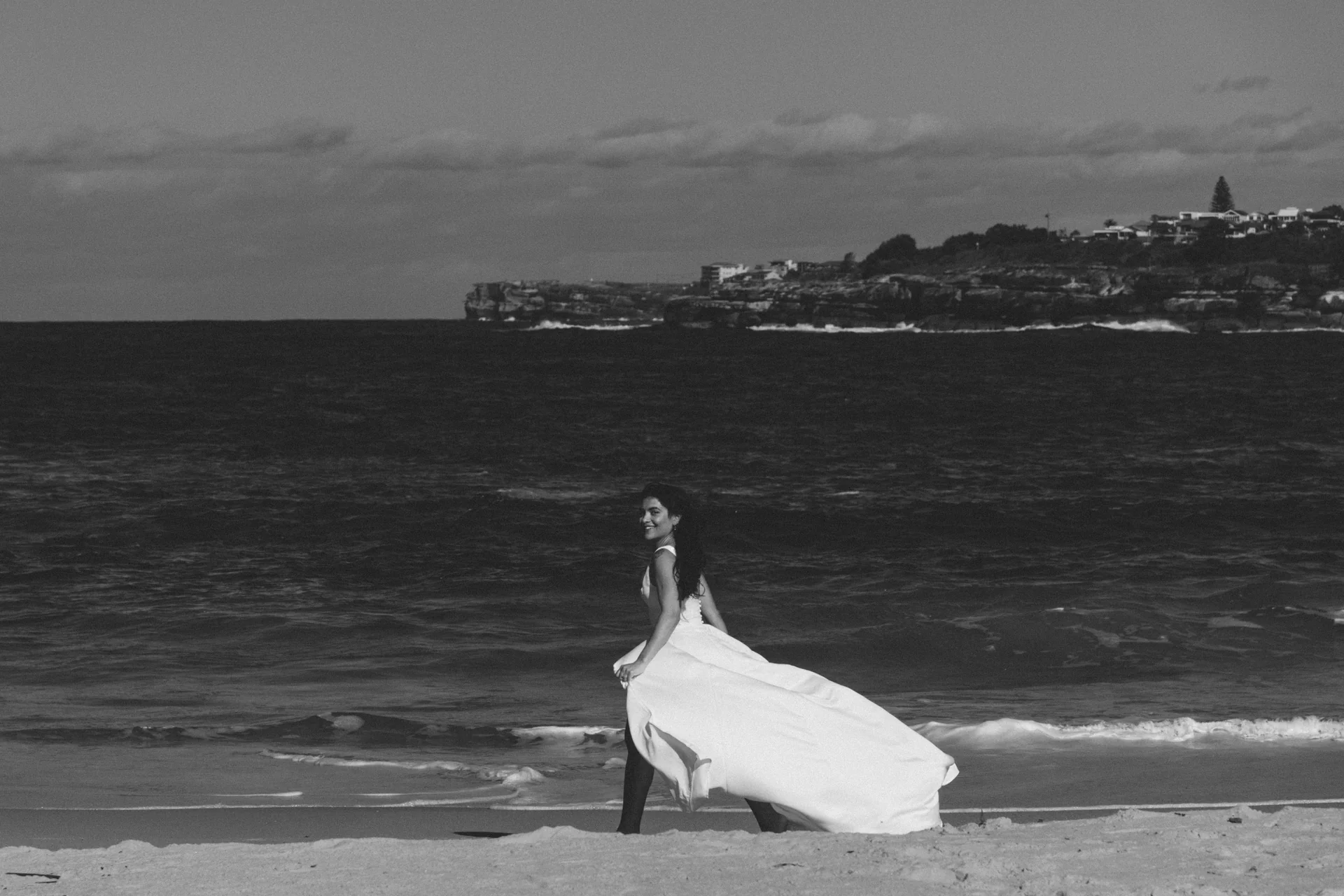 Down to the water, Lucia on the sand, black and white